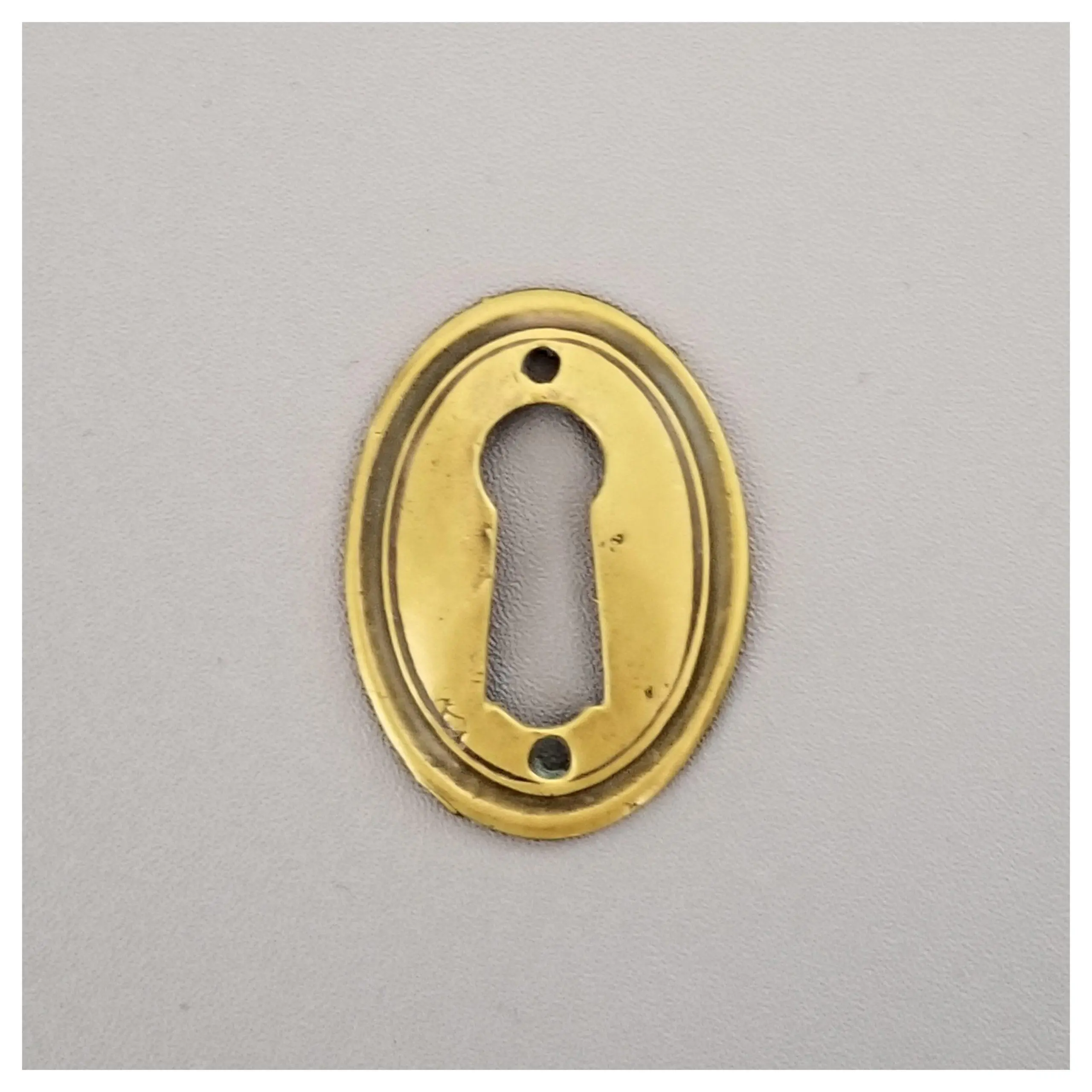 Pressed Oval Escutcheon